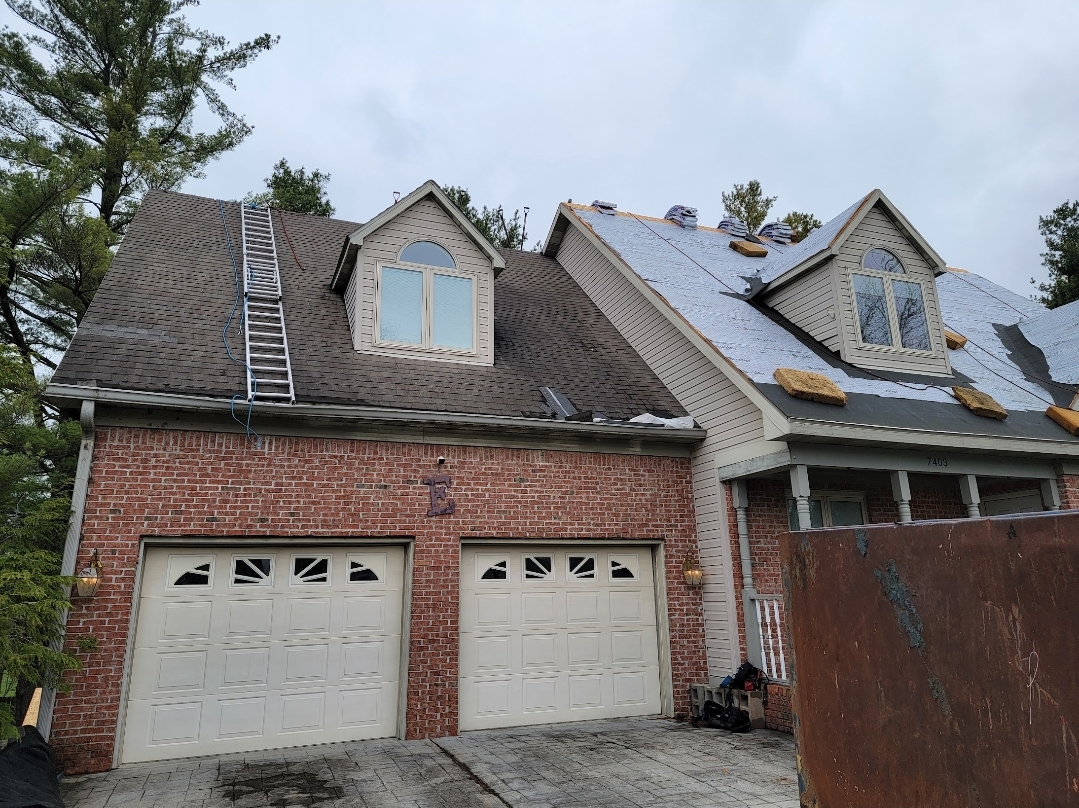 Roof replacement on 2-story brick home in Terre Haute Indiana. Half of the old shingles have already been removed and the rest is in progress.